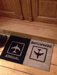 a pair of shoes sitting on the floor next to a door mat