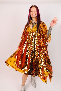 Get ready to steal the show in our dazzling mid paillette sequin caftan! This striking caftan is adorned with shimmering paillette sequins that will turn heads and make you the center of attention. Perfect for a night out on the town, a special occasion, or just because you deserve to feel fabulous. The flowy, relaxed fit make it comfortable to wear all night long, while the short length ensures drama and fun. These sequins on soft mesh assure comfort and they are unlined meaning they won't be t V-neck Kaftan For Party And Festivals, Embellished Sequin Dress For Festive Fall Occasions, Embellished Sequin Dress For Festive Fall Events, Gold V-neck Kaftan For Party, Fall Festive Embellished Sequin Dress, Festive Fall Embellished Sequin Dress, Glamorous Festival Dress For Costume Party, Fall Festive Sequin Dress With Contrast Sequin, Festive Fall Sequin Dress With Contrast Sequins