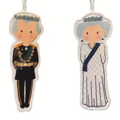 two key chains with an image of the queen and prince