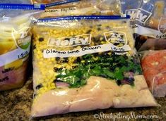 bags of frozen food sitting on top of a counter next to other foodstuffs