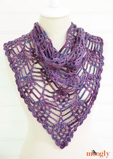 a crocheted purple scarf on top of a mannequin