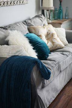 a living room filled with furniture and pillows