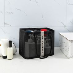 a black bag sitting on top of a counter next to a white box and other items