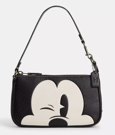 Measurements Length: 7.5" Height: 4.5" Width: 2.0" Materials Refined pebble leather Fabric lining Handle Handle with 6.25" drop Features Zip-top closure Inside multifunction pocket Two credit card slots Additional Details Disney x Coach/ ©Disney Louis Vuitton Mickey Mouse, Louis Vuitton Mickey, Coach Nolita 19, Coach X Disney, Nolita 19, Coach Nolita, Coach Disney, Convertible Purse, Tas Bahu