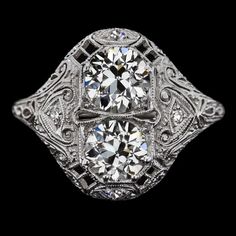 an antique style diamond ring with filigrees