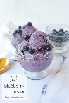 blueberry ice cream in a glass bowl with spoons