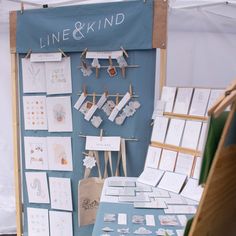 a table with cards and pictures on it in front of a sign that says line & kind