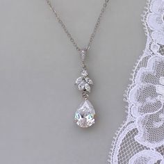 "Annie silver tone crystal bridal necklace has been designed by us to match our popular Annie earrings. A beautiful teardrop sits beneath a marquise crystal cluster all in white gold, for an elegant and classy bridal necklace. Length-16.5\" chain plus 1.5\" extender (optional) Crystal zircons set in a tarnish free rhodium base. (aka white gold) 💜 Available in rose gold, silver (rhodium) 💟 Items that coordinate or are frequently bought together (such as in photos/collages): Bracelets: https://w Wedding Pear-shaped Diamond Cut Drop Necklace, White Gold Drop Bridal Necklace With Cubic Zirconia, White Gold Cubic Zirconia Drop Bridal Necklace, Silver Teardrop Bridal Necklace With Sparkling Stones, Silver Drop Crystal Bridal Necklace, Dazzling Teardrop Bridal Necklace For Anniversary, Sparkling Dangle Necklaces For Wedding, White Gold Teardrop Necklace For Wedding, Sparkling Dangle Necklace For Wedding