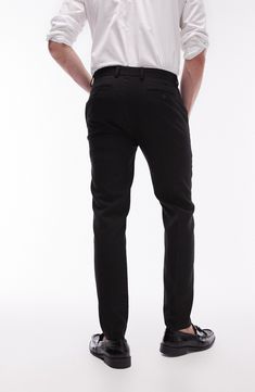 A lightly textured weave distinguishes neatly pressed trousers tailored in a skinny fit that looks smart whether worn with casual or formal styles. 30 1/2" inseam; 13" leg opening; 10 1/2" front rise; 14" back rise (size 32) Zip fly with hook-and-bar closure Front slant pockets; back welt pockets 64% polyester, 34% viscose, 2% elastane Dry clean Imported Casual Business Bottoms With Pressed Crease, Casual Bottoms With Pressed Crease For Business, Stretch Tapered Leg Chinos For Work, Slim Fit Elastane Chinos For Work, Workwear Slim Fit Elastane Chinos, Slim Fit Straight Chinos For Business Casual, Tailored Straight Chinos For Business Casual, Elastane Chinos For Business Casual, Straight Leg Elastane Dress Pants For Business Casual