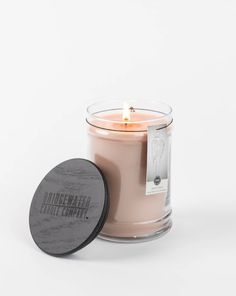 a candle that is sitting next to a container