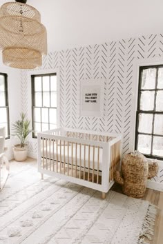 a baby's room with white walls and black windows