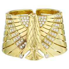 For Sale on 1stDibs - Absolutely stunning so special and unique this Egyptian Revival Horus Falcon Diamond Bracelet by Cartier is everything! Made in 18k Yellow Gold with round Cartier Diamond Bracelet For Anniversary, Cartier Bangle With Single Cut Diamonds, Cartier Round Diamond Bracelet With Brilliant Cut, Cartier Diamond Bangle For Wedding, Cartier Diamond Bangle For Anniversary, Cartier Diamond Bangle For Formal Occasions, Cartier Luxury Diamond Bangle, Luxury Cartier Diamond Bangle, Cartier Diamond Accents Bracelet Jewelry