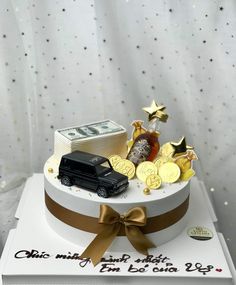 a birthday cake with money and cars on top