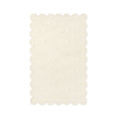 a white placemat with scalloped edges and stars on it, against a white background