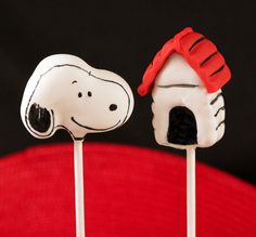 two marshmallows with snoopy hats on them