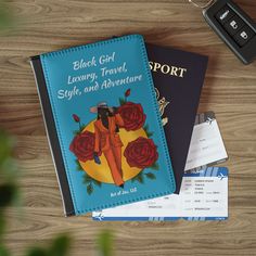 two passport books sitting on top of a wooden table