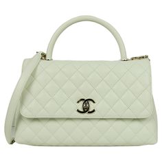 Chanel White Caviar Leather Quilted Small Coco Handle Flap Bag Made In: Italy Year of Production: 2023 Color: White Hardware: Pale goldtone Materials: Caviar leather Lining: Leather Closure/Opening: Flap top with CC twist lock Exterior Pockets: Back patch pocket Interior Pockets: Two compartments separated by zipper pocket, patch pockets, and a central zipper compartment.  Exterior Condition: Excellent  Interior Condition:  Excellent Includes: Dustbag, tag Measurements: 11.25"L x 7"H x 4.5"D Handle Drop: 3.25" Strap Drop: 19.25" Dior New Look, Sportswear Store, Vintage Chanel Bag, White Hardware, Coco Handle, Chanel White, 2023 Color, Chanel Brand, Togo Leather