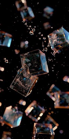 an image of some ice cubes floating in the air with water droplets on them