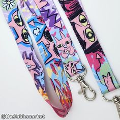 "This lil guy, this creatchur, this FELLA this MENACE this GROMBLIN is very busy going through so many moods and activities! All of which are captured on this unique double sided lanyard! This lanyard is for all the silly gooses and feral friends.  Great for holding keys, enamel pins, work badges & more!  Lanyards measure 35\" total.  ** keep in mind this item is made in small batches so slight variations in color may occur." Lanyard Ideas, Weird Gifts, Work Badge, Key Lanyard, School Aesthetic, Product Ideas, Very Busy, Birthday Wishlist, Weird Art