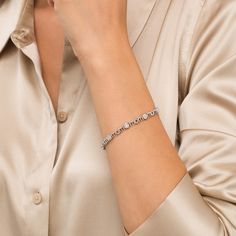 Simple and shimmering, this diamond bracelet is just Mom's style. Fashioned in sterling silver, this design features diamond composites - each centered with a diamond artfully set to enhance size and sparkle. The word "mom" is sculpted as print-font links to complete the alternating pattern. Captivating with 1/6 ct. t.w. of diamonds and a bright polished shine, this 7.5-inch bracelet secures with a tongue and groove clasp. Diamond White Platinum Diamond Bracelet For Anniversary, Platinum Diamond Bracelet With Accents, Diamond White Diamond Bracelet With Jubilee Design, Diamond Bracelet With Pave Setting For Anniversary, Platinum Diamond Bracelet For Anniversary (jubilee Style), Silver Diamond Bracelet With Pavé Setting, Silver Diamond Bracelet In Fine Jewelry Style, Anniversary Platinum Diamond Bracelet With Jubilee Style, Diamond White Jubilee Diamond Bracelet