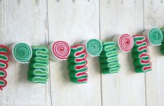 green and red candy canes are hanging on the wall