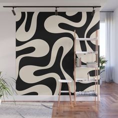 an abstract black and white wall mural in a living room