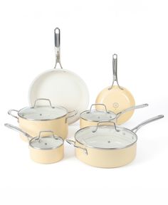 an assortment of pots and pans on a white background