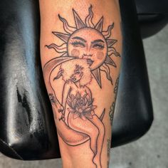 a woman with a sun tattoo on her leg