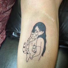 a woman with a cat tattoo on her leg is shown in black and grey ink