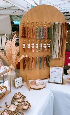 an assortment of earrings are on display at a market stall, with other items displayed in the background