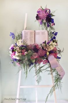 a ladder decorated with flowers and an open book