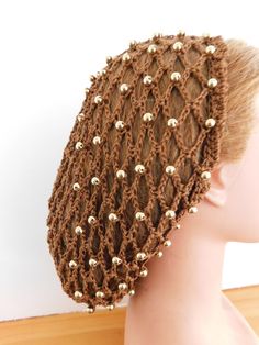 Lots of work went into this one.  This beautiful fashion hair net was crocheted totally by hand with crocheted inset gold beads.  Being cotton, you can be assured that you will have comfort for year round use.   We made this totally adjustable so that you will not have nasty tight elastics or funny looks "here and there" . No gaping holes for your hair to fall through.  You have total control!!   If our snoods are too long for you, you can also pin them up from the bottom under,    Our net caps are designed for women to protect even the most luxuriant locks.  Keeps hair under control fashionably. Stretches to fit.  No uncomfortable elastic anywhere! No ties to deal with!  Notice the nice band?  Ready for flower or other embellishments.  We handmake our fashion head coverings one-by-one in Head Coverings, Crochet Cap, Hair Net, Cap Designs, Crochet Videos Tutorials, Crochet Woman, Fashion Hair, Cap Design, Head Covering