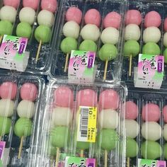 many different colored cake pops in plastic containers