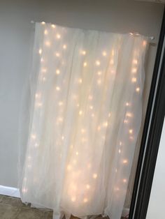 a white curtain with lights hanging from it