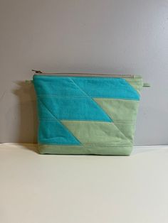 "This fabulous quilted zipper cosmetic bag is handmade with geometric diagonal and stripes patchwork. modern look with color block placement. Well made and very stylish. It is all-purpose medium size makes it roomy enough as a day pouch, cosmetics bag, a clutch or travel necessities. You could also use it as a project bag for small crafts or to organize your small tools and notions. Perfect gift for anybody. Exterior is cotton base fabric patchwork and natural cotton batting. Lining is gray heav Sew Patchwork, Quilted Cosmetic Bag, Easy Patchwork, Small Dog Harness, Small Crafts, Tea Cup Dogs, Quilted Bags, Small Tools, Fabric Patchwork