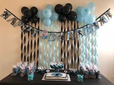 a table with balloons and decorations on it