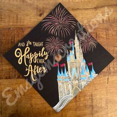 a graduation cap with the words happily never after and fireworks in the sky above it