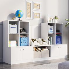 a white bookcase filled with lots of books next to a wall mounted art piece