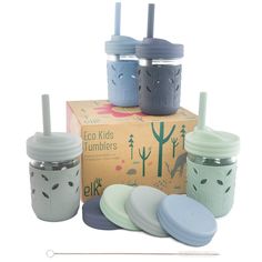 the eco kids tumblers are on display in front of a cardboard box with lids