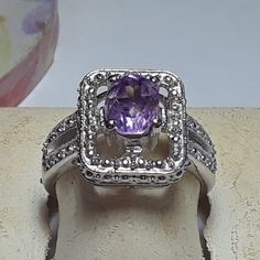 This Pretty Ring Features A Center 8x6mm Oval Amethyst, Set With 4 Sterling Prongs In The Center Of A Open Rectangular Halo. On One End Of The Frame There Is 1 Natural Small Round Diamond, Also Prong Set. The Rectangular Center Measures Aprox 9/16" X 7/16" And The Ring Weighs Aprox 5.049 Grams Of Solid (Stamped 925 Inside The Shank) Sterling Silver. This Pretty Amethyst & Diamond Ring Has A Msrp Of $499.00. Finger Size 8 (This Ring Can Be Sized By Your Local Jeweler, At Your Cost, We Do Not Size Oval Hallmarked Amethyst Ring In White Gold, Classic Silver Amethyst Ring With Gemstone Accents, Silver Oval Amethyst Ring With Gemstone Accents, Oval Silver Amethyst Ring With Gemstone Accents, Oval Amethyst Ring With Gemstone Accents In Sterling Silver, Silver Amethyst Ring With Gemstone Accents For Anniversary, Classic Silver Rings With Gemstone Accents, Silver Oval Amethyst Ring With Halo Setting, Oval Amethyst Ring With Halo Setting In Sterling Silver