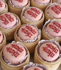 there are many small cakes with red frosting in the shape of words on them