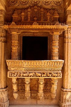 an intricately carved balcony in the middle of a building