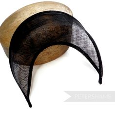 The shape of this season (and next's) has arrived! Halo crowns have stormed the millinery world and are the perfect step up from a chunky headband for a special occasion. Made from a double layer of high-quality stiffened black sinamay, this shape has a domed front with a hollow underside, sinamay bias finished edges and tapered ends that sit nicely at the side of the head. You will need to fit a headband to this shape to make it functional, and our 5mm satin covered headbands do the job just pe Black Adjustable Fascinator With Structured Crown, Adjustable Structured Crown Hair Accessories For Evening, Black Adjustable Mini Hats With Pinched Crown, Adjustable Black Costume Hat With Pinched Crown, Black Costume Hat With Pinched Crown And Adjustable Fit, Black Structured Crown Headpiece For Summer, Adjustable Black Costume Hat With Round Crown, Adjustable Black Mini Hat With Round Crown, Black Adjustable Mini Hat With Round Crown