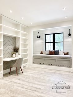 a cat sitting on the floor in front of a white bookcase and window seat