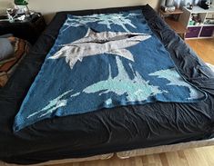 a bed with a blue blanket on top of it