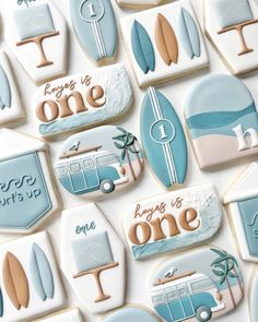 decorated cookies are arranged in the shape of surfboards and beach scenes with words on them