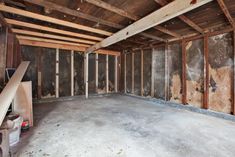 an unfinished room with wood framing and walls