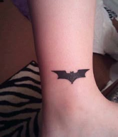 a small bat tattoo on the ankle