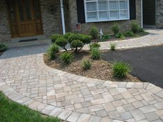 a brick driveway in front of a house