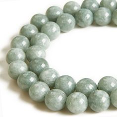 two strands of light green jade beads on a white background